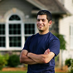 a proud homeowner with their arms crossed