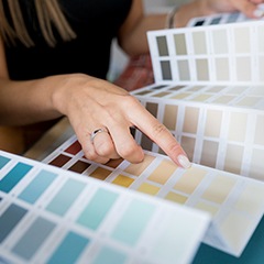 Woman pointing to color swatches during color consultation 
