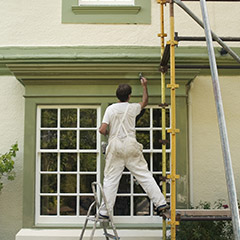 Man painting on a scaffold