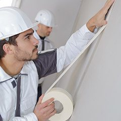 Men taping prior to painting