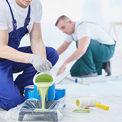 Two men pouring paint