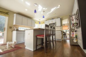 a kitchen with cabinets that are painted white