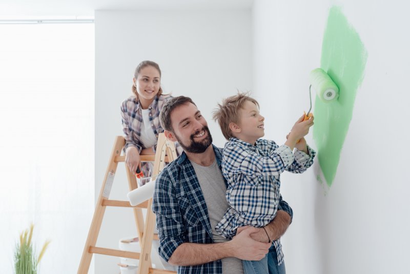 family painting kid’s room together