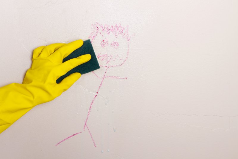 closeup of person cleaning walls 